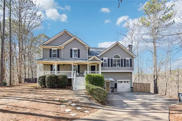 a front view of a house with a yard and garage