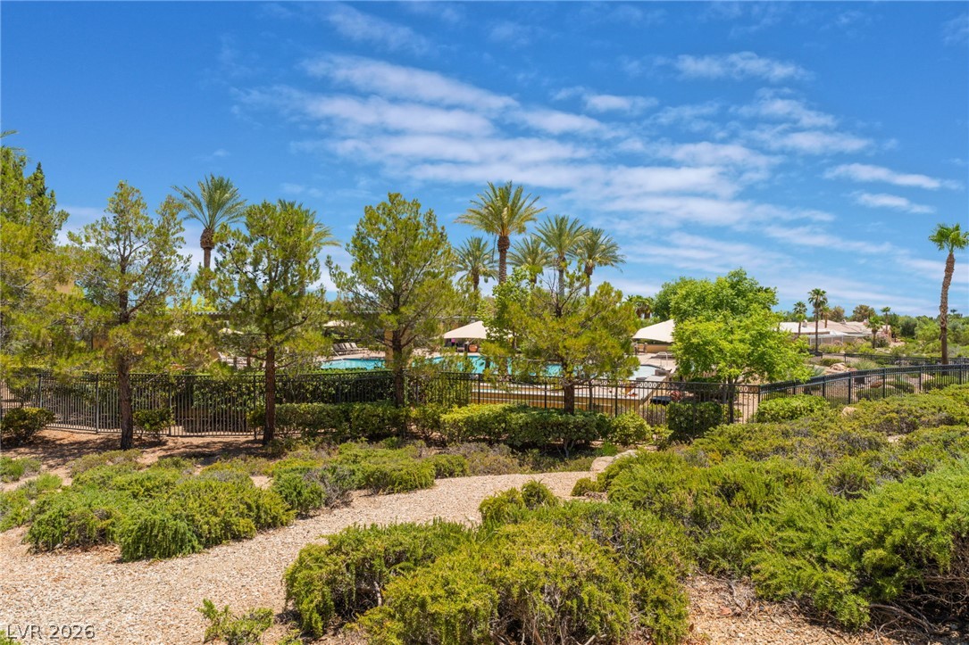 5389 Progresso Street Las Vegas, NV 89135 - Photo 33 of 41 A vibrant community pool, framed by lush greenery, promises endless summer enjoyment.