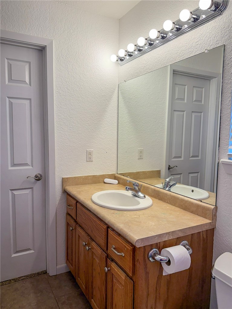 70 Walthall Road Russellville, AR 72802 - Photo 22 of 51 Bathroom 2 vanity with a white oval sink, chrome faucet, and a light wood-finish cabinet