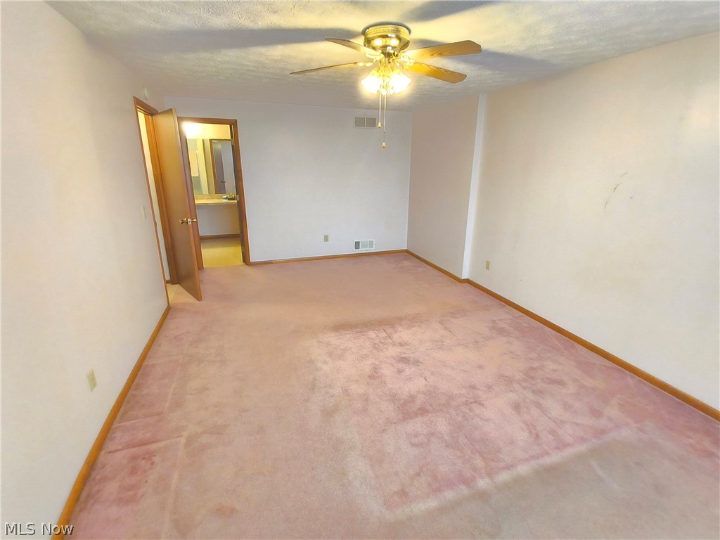 2672 Crackel Road Aurora, OH 44202 - Photo 21 of 38 Carpeted spare room with ceiling fan and a textured ceiling