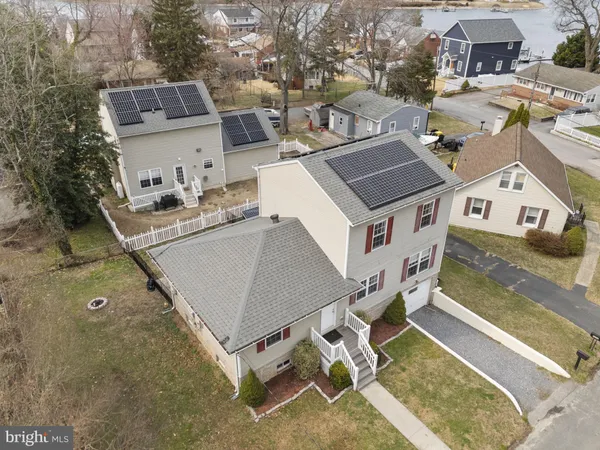 an aerial view of a city with ocean view in back