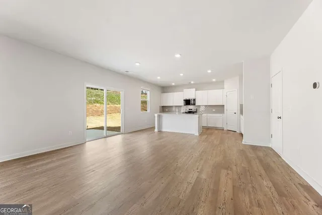 a kitchen with granite countertop white cabinets and white appliances