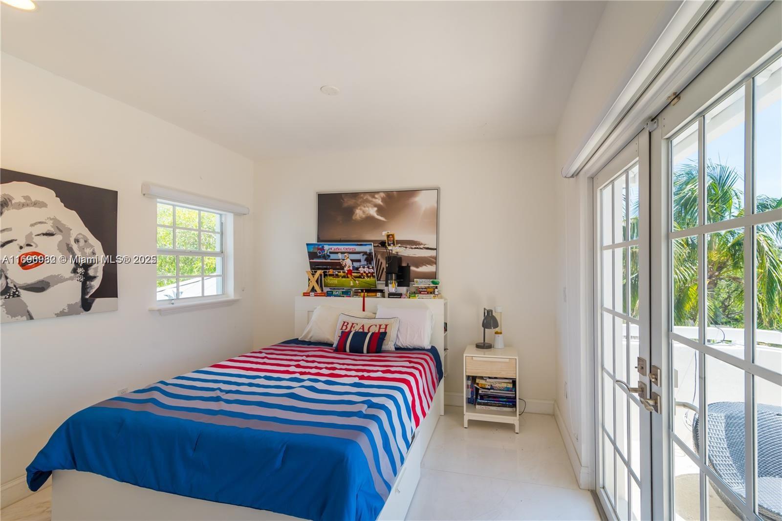 325 Pacific Road Key Biscayne, FL 33149 - Photo 16 of 31 a bedroom with a bed and a window