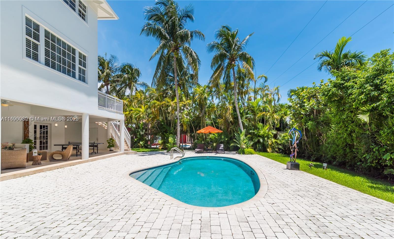 325 Pacific Road Key Biscayne, FL 33149 - Photo 23 of 31 a swimming pool with yard and outdoor seating