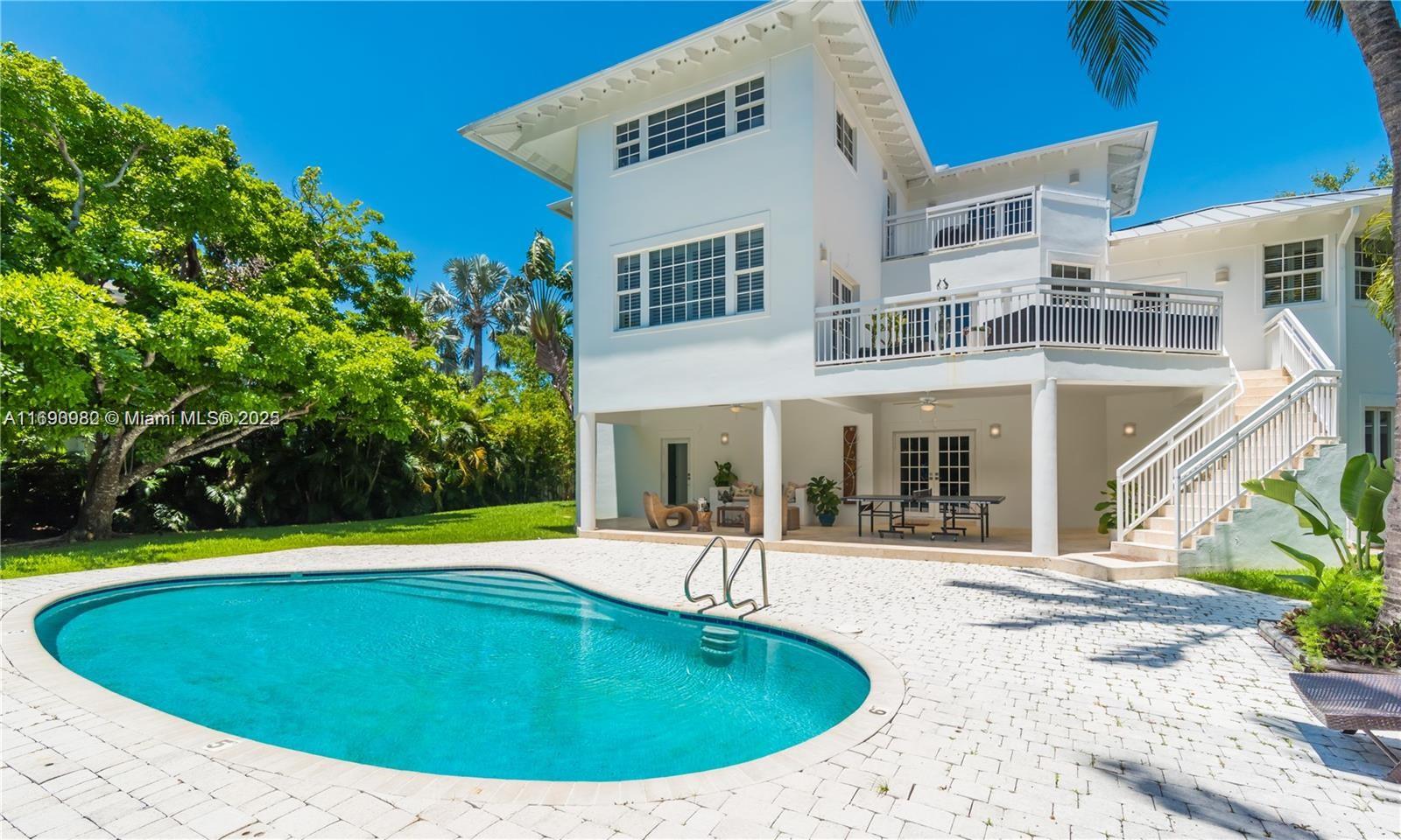 325 Pacific Road Key Biscayne, FL 33149 - Photo 25 of 31 a view of a house with a swimming pool and sitting area