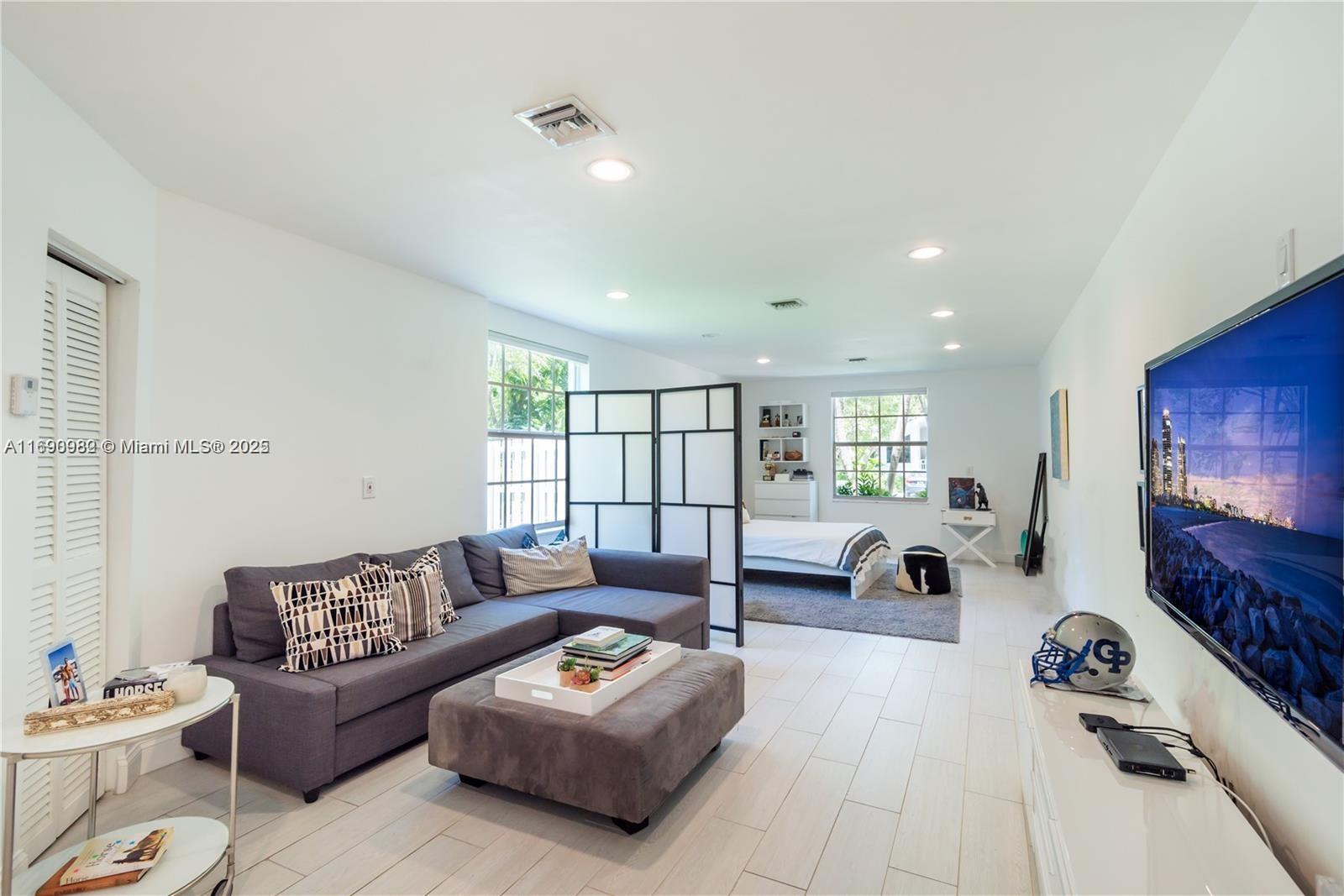 325 Pacific Road Key Biscayne, FL 33149 - Photo 4 of 31 a living room with furniture and a flat screen tv