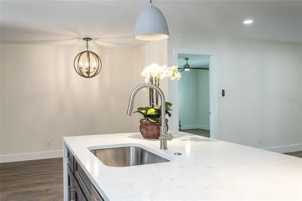 a kitchen with a sink and a chandelier
