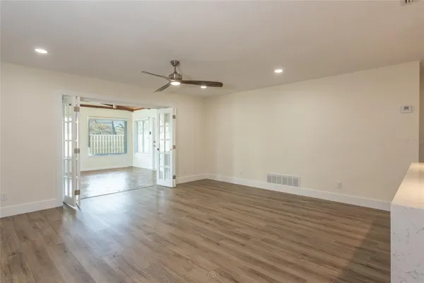 wooden floor in an empty room with a window