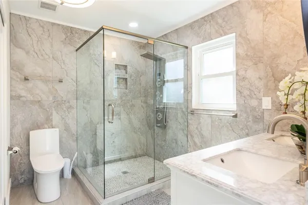 a bathroom with a shower and a toilet