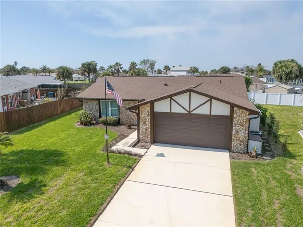 an aerial view of a house with a yard