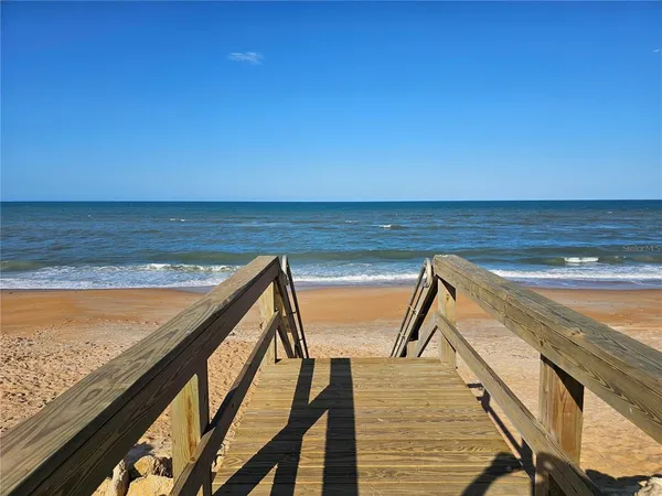 a view of a patio with a table and chairs