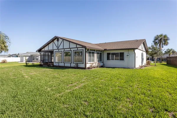 a view of a house with a yard balcony and sitting area