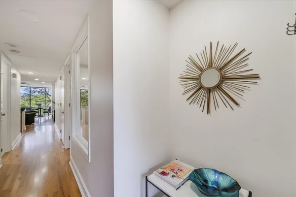 a view of entryway and hall with wooden floor