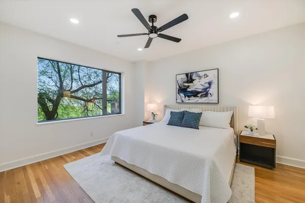 a bedroom with a bed and a large window