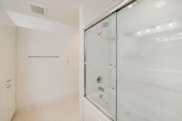 a bathroom with a shower and a glass door