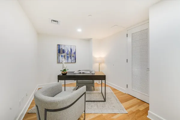 a living room with furniture and a wooden floor