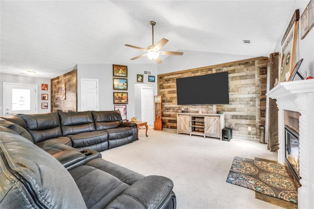 15 Tara Way Covington, GA 30016 - Photo 11 of 40 a living room with fireplace furniture and a flat screen tv