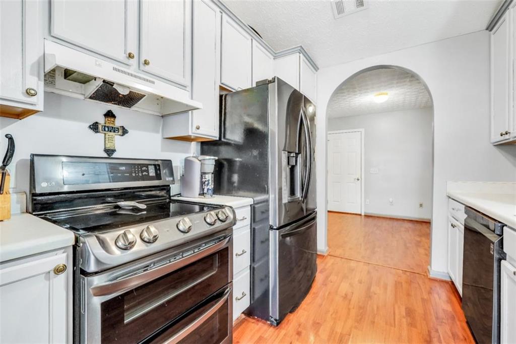 15 Tara Way Covington, GA 30016 - Photo 14 of 40 a kitchen with stainless steel appliances granite countertop a stove a refrigerator and a cabinets