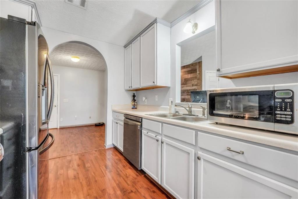 15 Tara Way Covington, GA 30016 - Photo 16 of 40 a kitchen with granite countertop stainless steel appliances and wooden cabinets