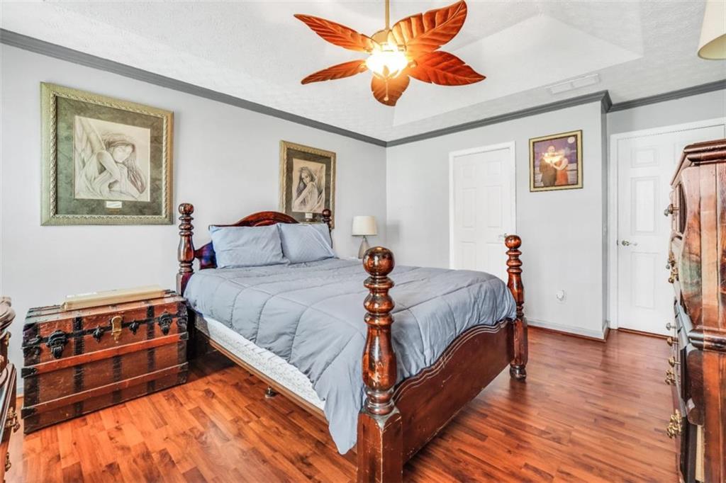 15 Tara Way Covington, GA 30016 - Photo 22 of 40 a bed room with a bed and a ceiling fan