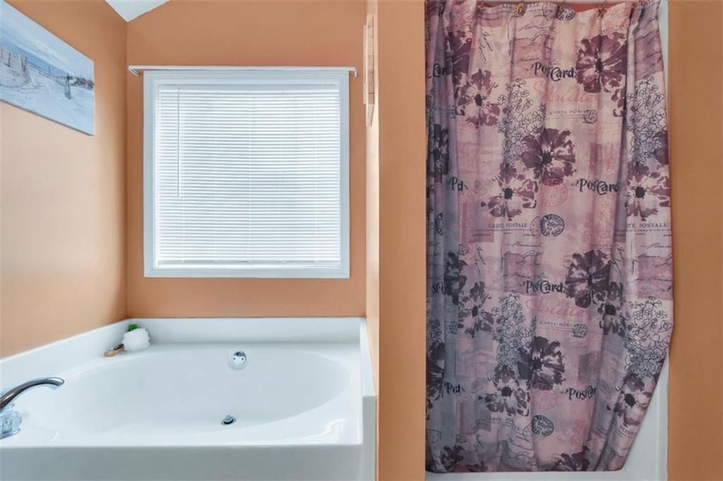 15 Tara Way Covington, GA 30016 - Photo 25 of 40 a bathroom with a bathtub and shower