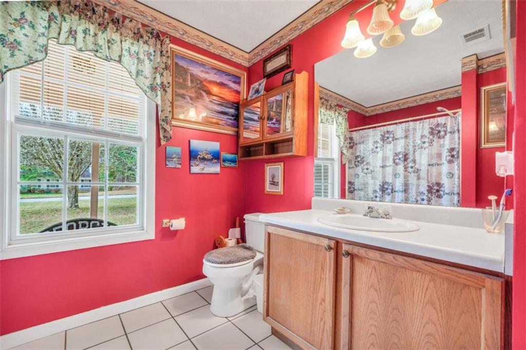 15 Tara Way Covington, GA 30016 - Photo 29 of 40 a bathroom with a sink a toilet and a shower