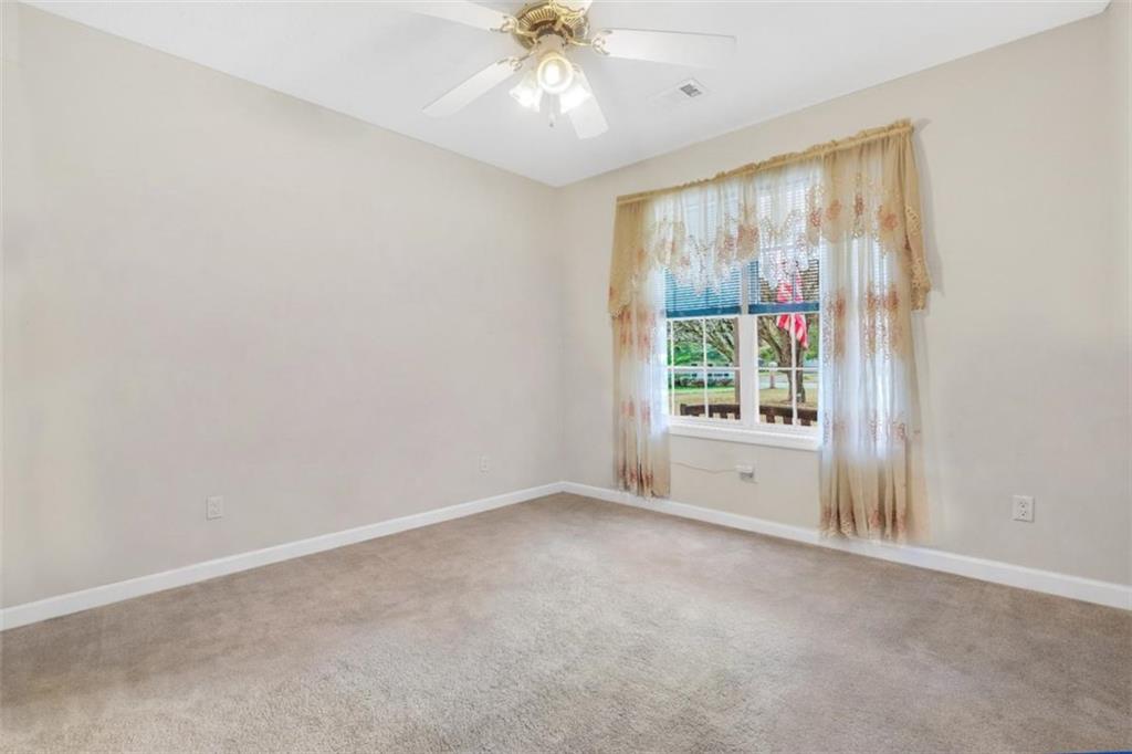 15 Tara Way Covington, GA 30016 - Photo 31 of 40 an empty room with a window and a ceiling fan