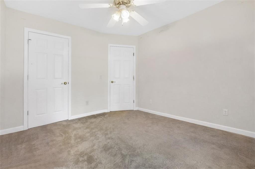 15 Tara Way Covington, GA 30016 - Photo 32 of 40 an empty room with a chandelier fan and windows