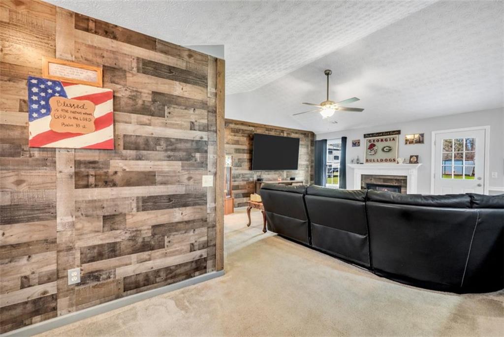 15 Tara Way Covington, GA 30016 - Photo 8 of 40 a room with furniture a flat screen tv and kitchen view