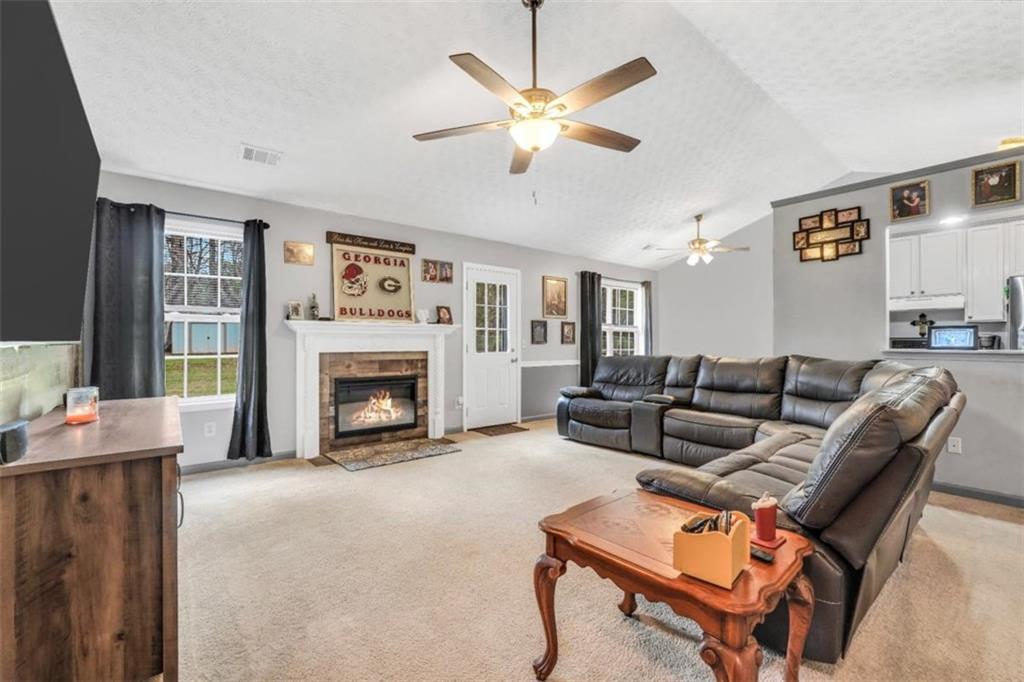 15 Tara Way Covington, GA 30016 - Photo 9 of 40 a living room with furniture a fireplace and a large window