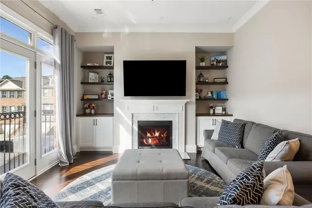 a living room with furniture a fireplace and a flat screen tv