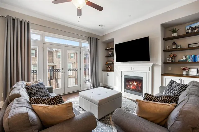 a living room with furniture a flat screen tv and a fireplace