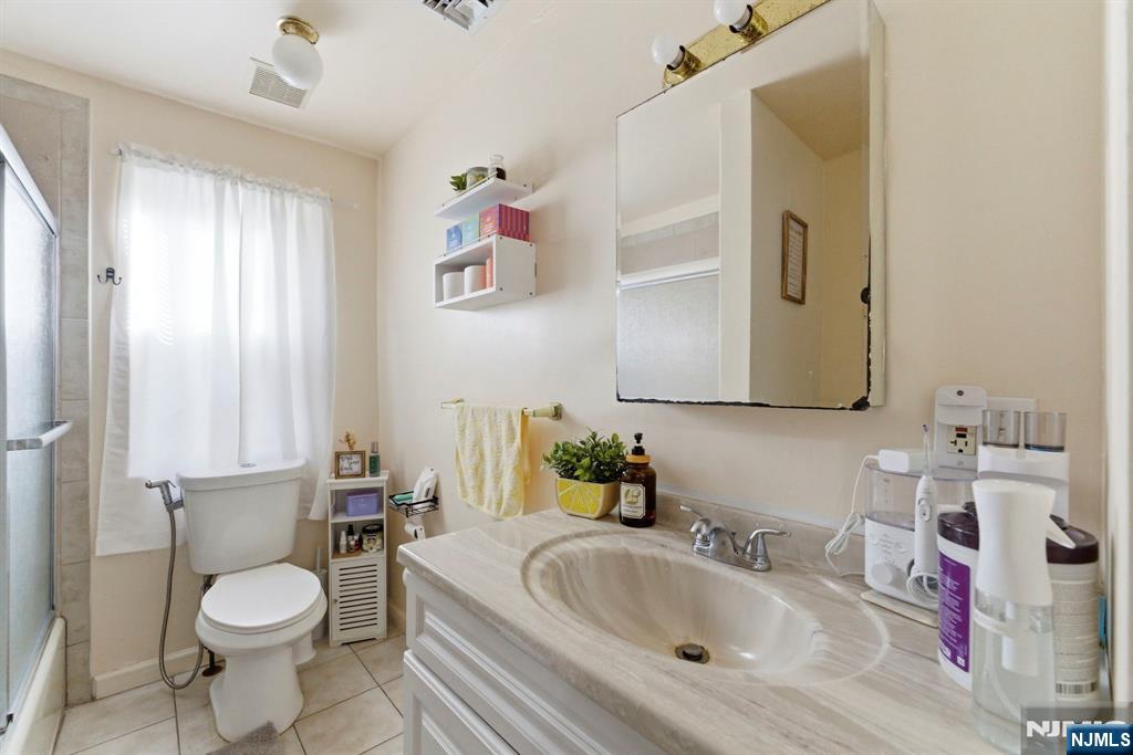 270 Westervelt Place Lodi, NJ 07644 - Photo 13 of 17 a bathroom with a sink toilet and mirror
