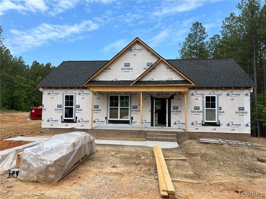 5 Forest Ridge Drive Scottsville, VA 24590 - Photo 2 of 8 a front view of a house with a yard outdoor seating and covered with trees
