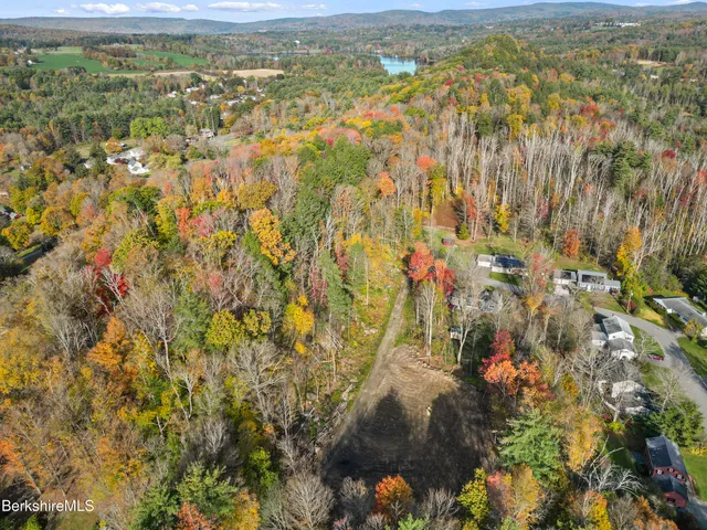 a view of residential houses with yard and mountain view