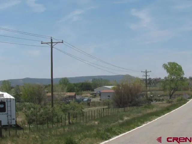 a view of a field of grass and trees