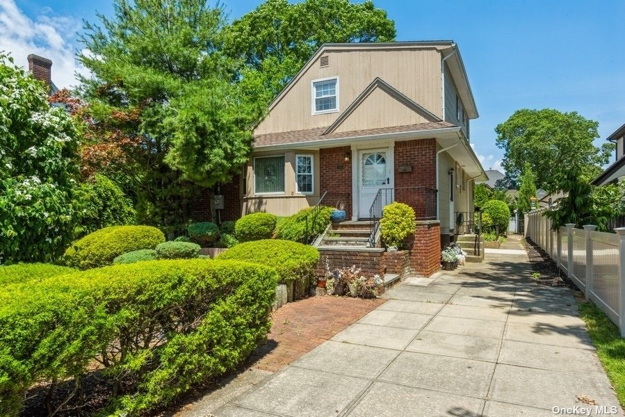580 Waterview Road Oceanside, NY 11572 - Photo 1 of 1 a front view of a house with garden