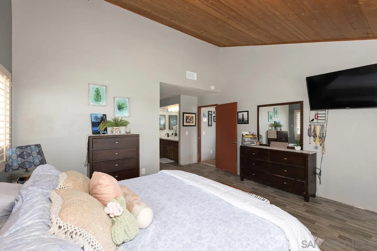 3245 Skytrail Ranch Road Jamul, CA 91935 - Photo 12 of 45 a bedroom with a bed and a flat screen tv