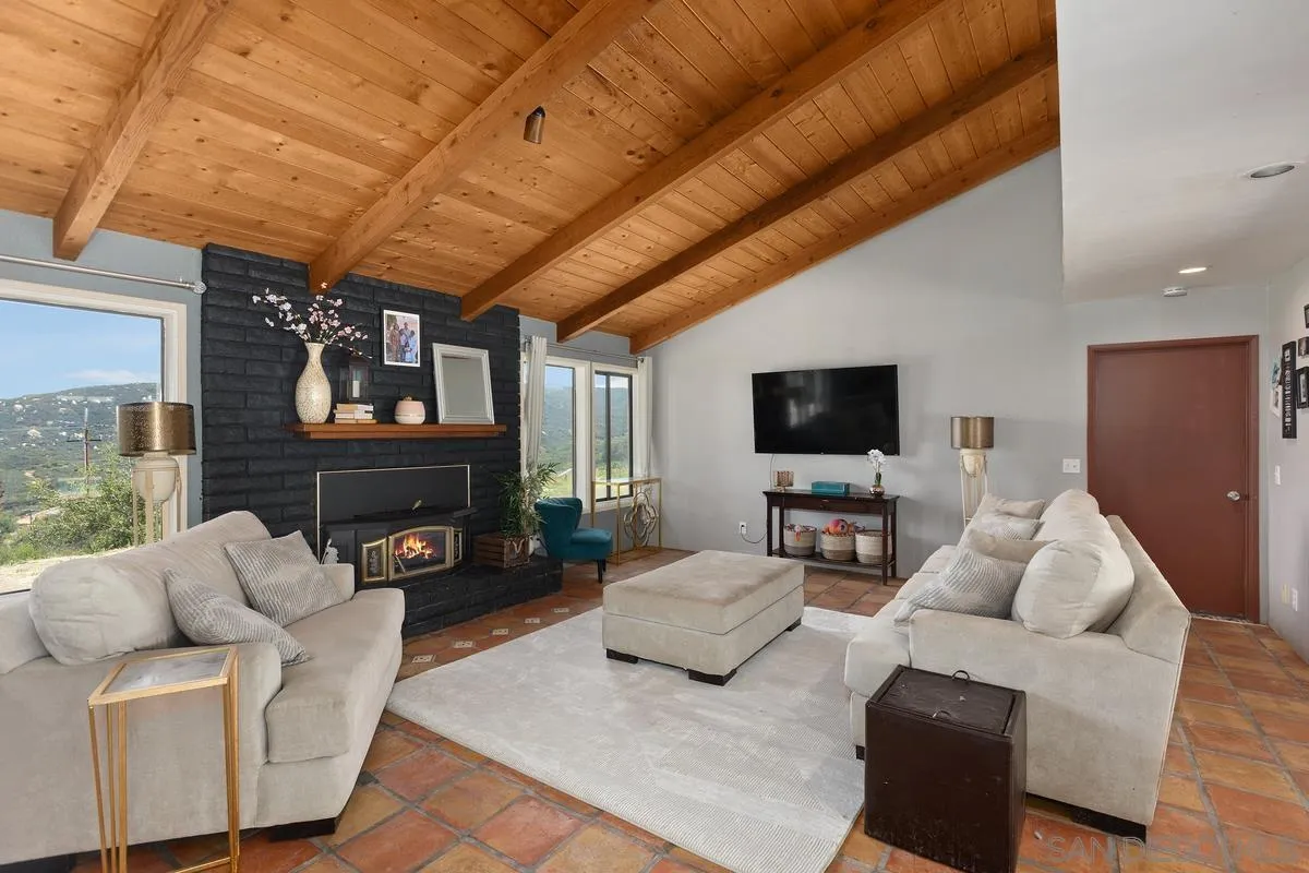 3245 Skytrail Ranch Road Jamul, CA 91935 - Photo 13 of 45 a living room with furniture and a flat screen tv