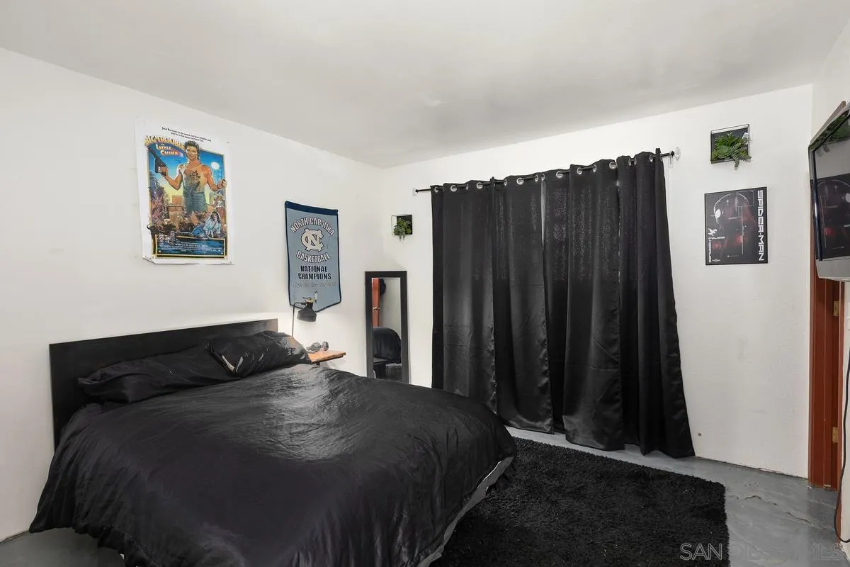 3245 Skytrail Ranch Road Jamul, CA 91935 - Photo 24 of 45 a bedroom with a bed window and wall painting