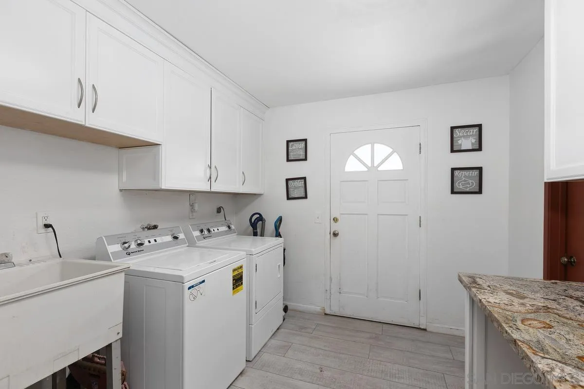 3245 Skytrail Ranch Road Jamul, CA 91935 - Photo 27 of 45 a utility room with cabinets washer and dryer