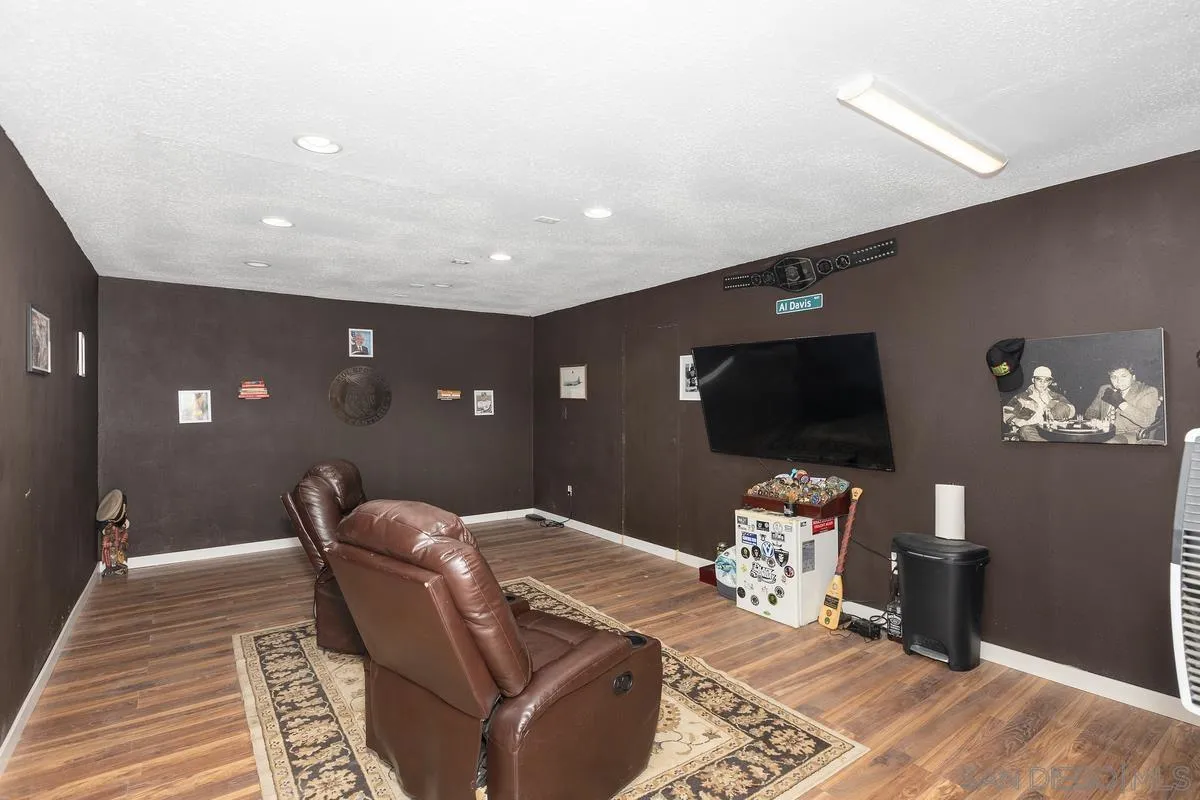 3245 Skytrail Ranch Road Jamul, CA 91935 - Photo 31 of 45 a living room with furniture and a flat screen tv