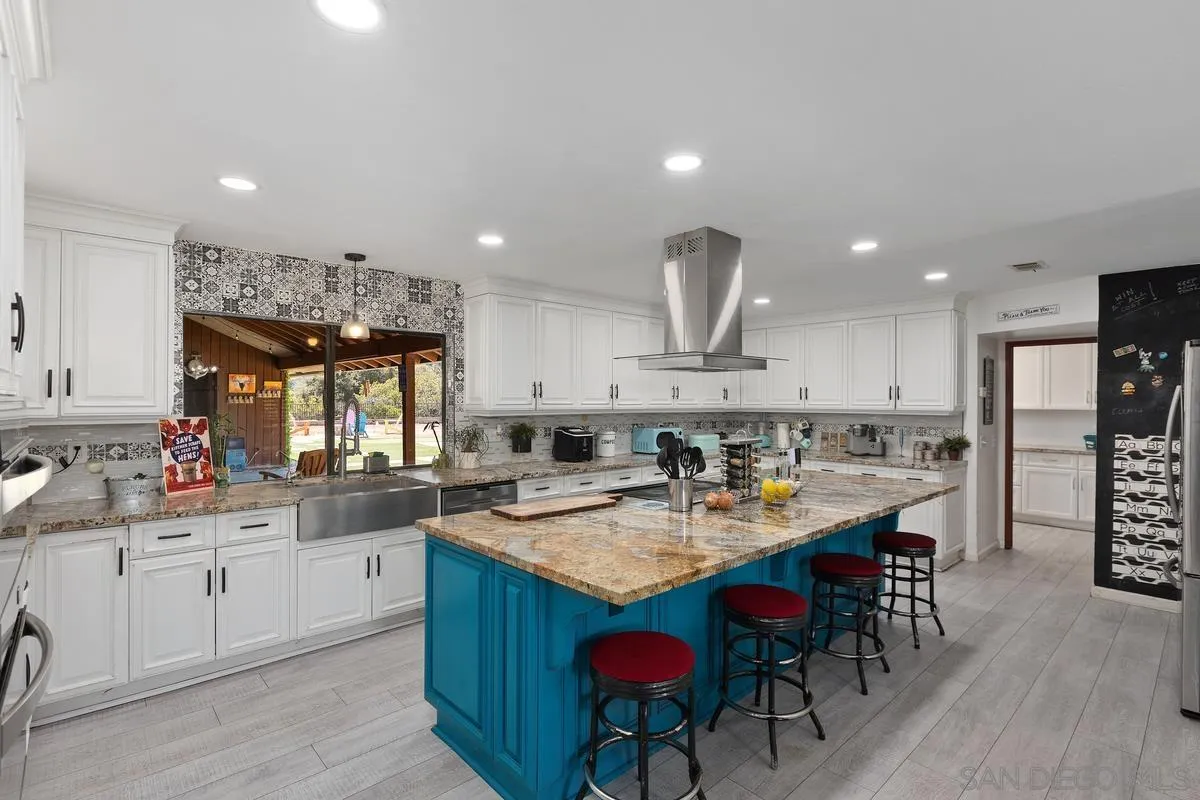 3245 Skytrail Ranch Road Jamul, CA 91935 - Photo 6 of 45 a kitchen with a sink a cabinets and wooden floor