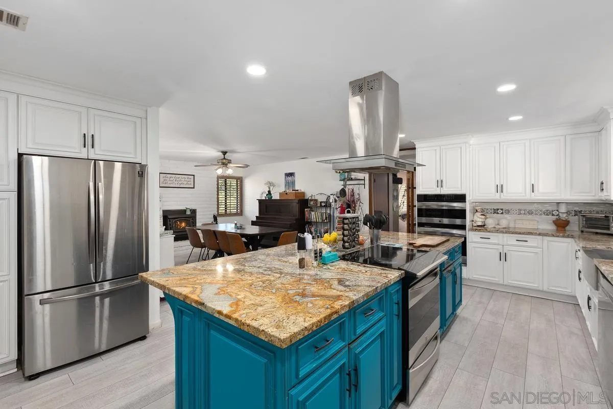 3245 Skytrail Ranch Road Jamul, CA 91935 - Photo 8 of 45 a kitchen with stainless steel appliances granite countertop a sink stove and refrigerator