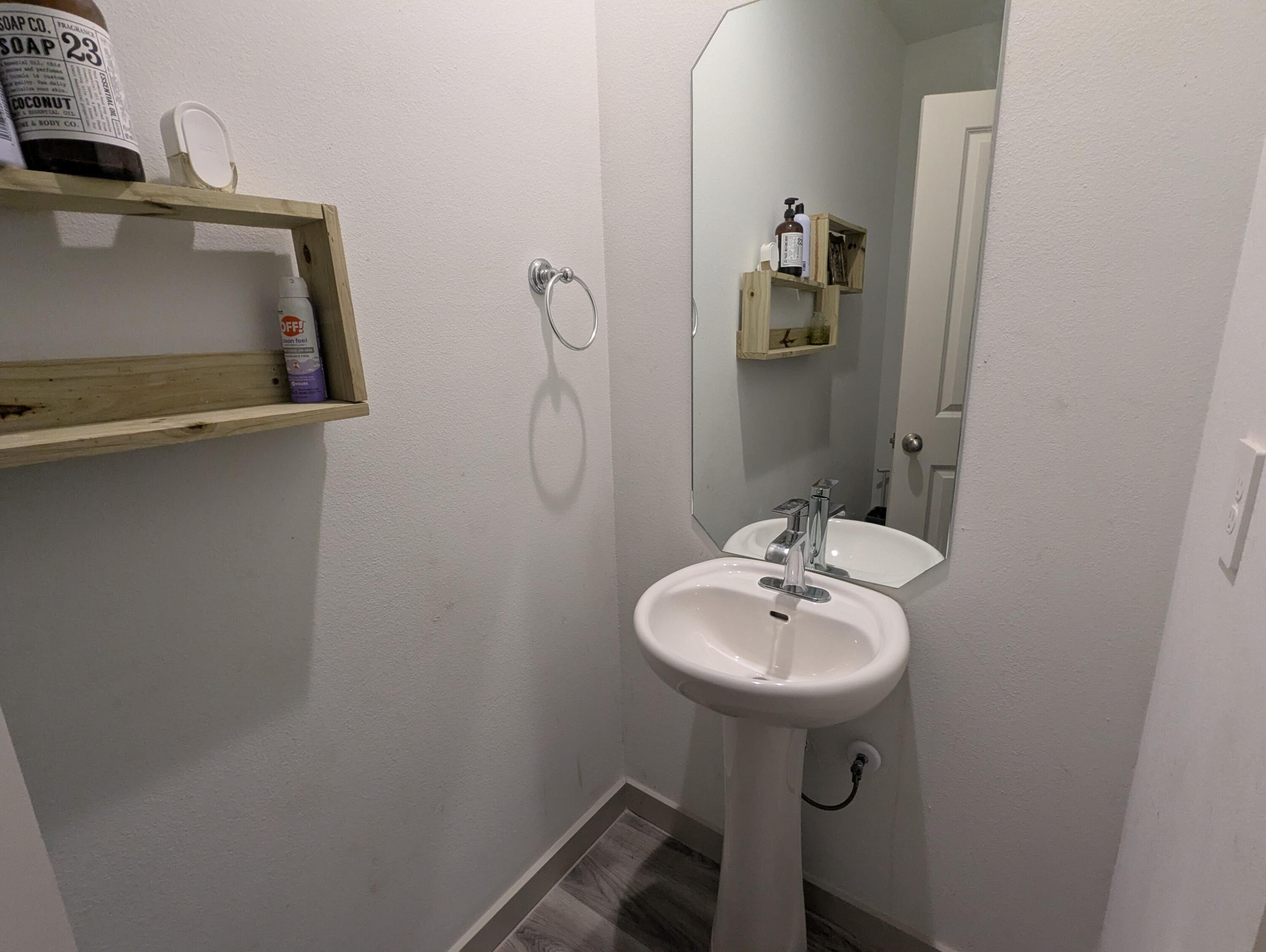 6802 55th Street Lubbock, TX 79407 - Photo 28 of 46 a bathroom with a sink a mirror and a toilet
