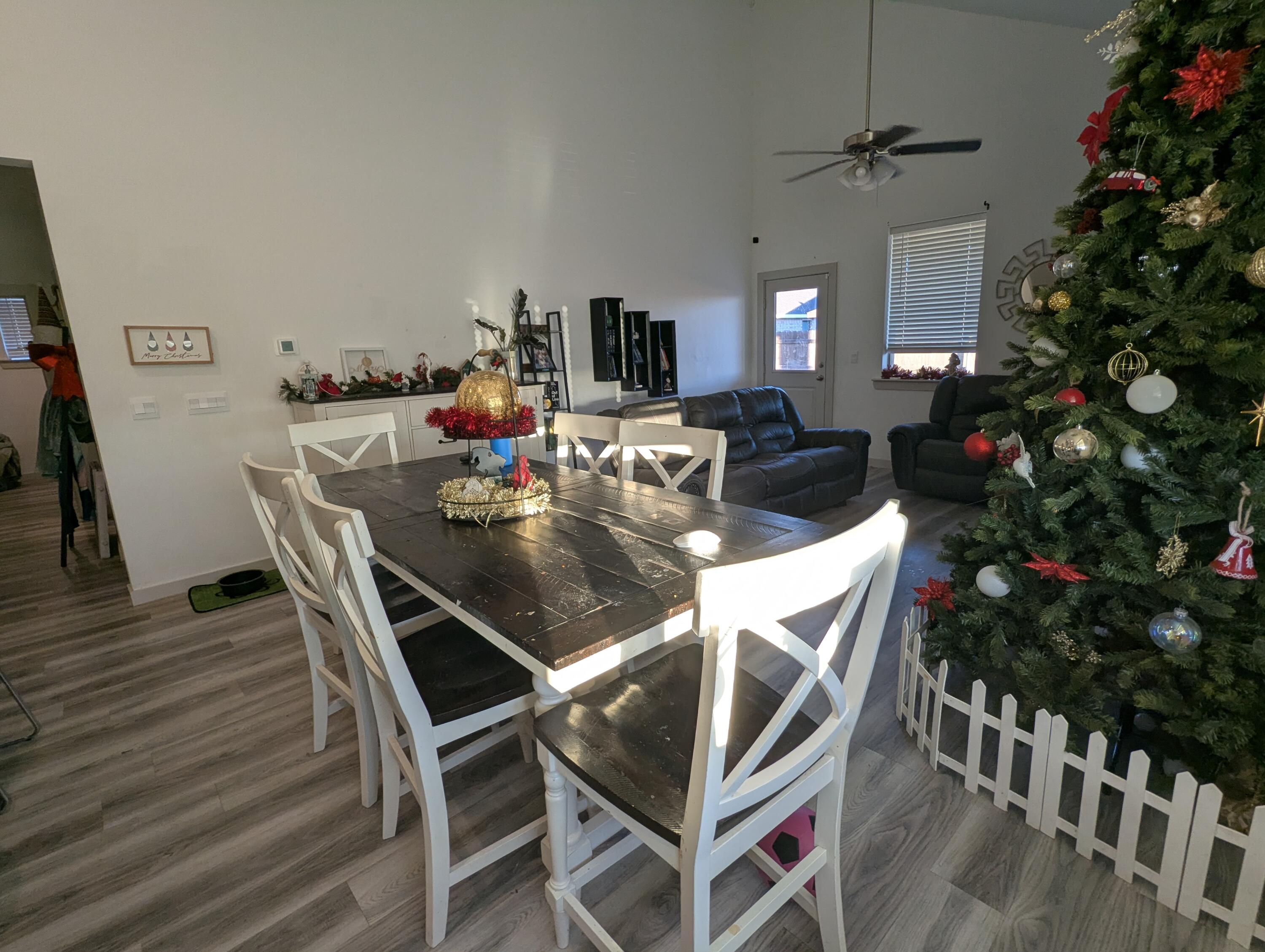 6802 55th Street Lubbock, TX 79407 - Photo 9 of 46 a view of a dining room with furniture and wooden floor