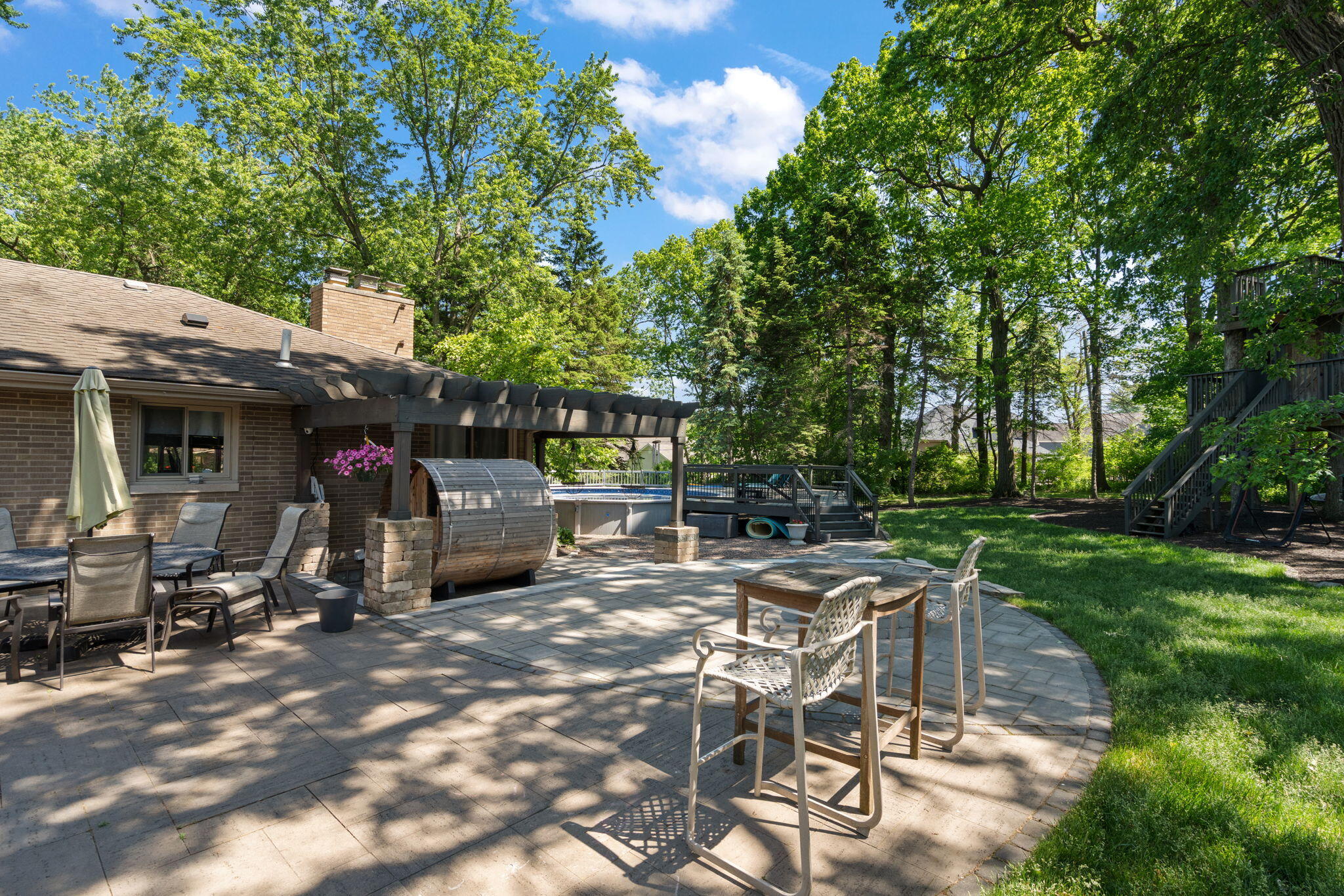 11728 Monroe Place Crown Point, IN 46307 - Photo 34 of 44 a view of a patio with table and chairs and a large tree