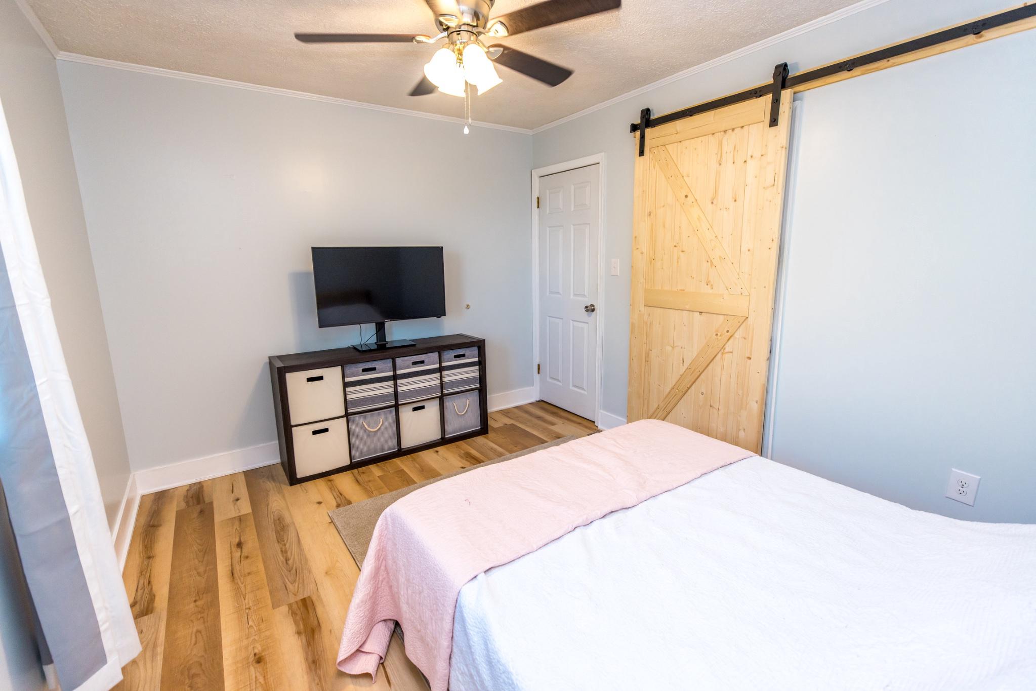 3427 York Street Manchester, MD 21102 - Photo 11 of 26 a bedroom with a bed and a flat screen tv