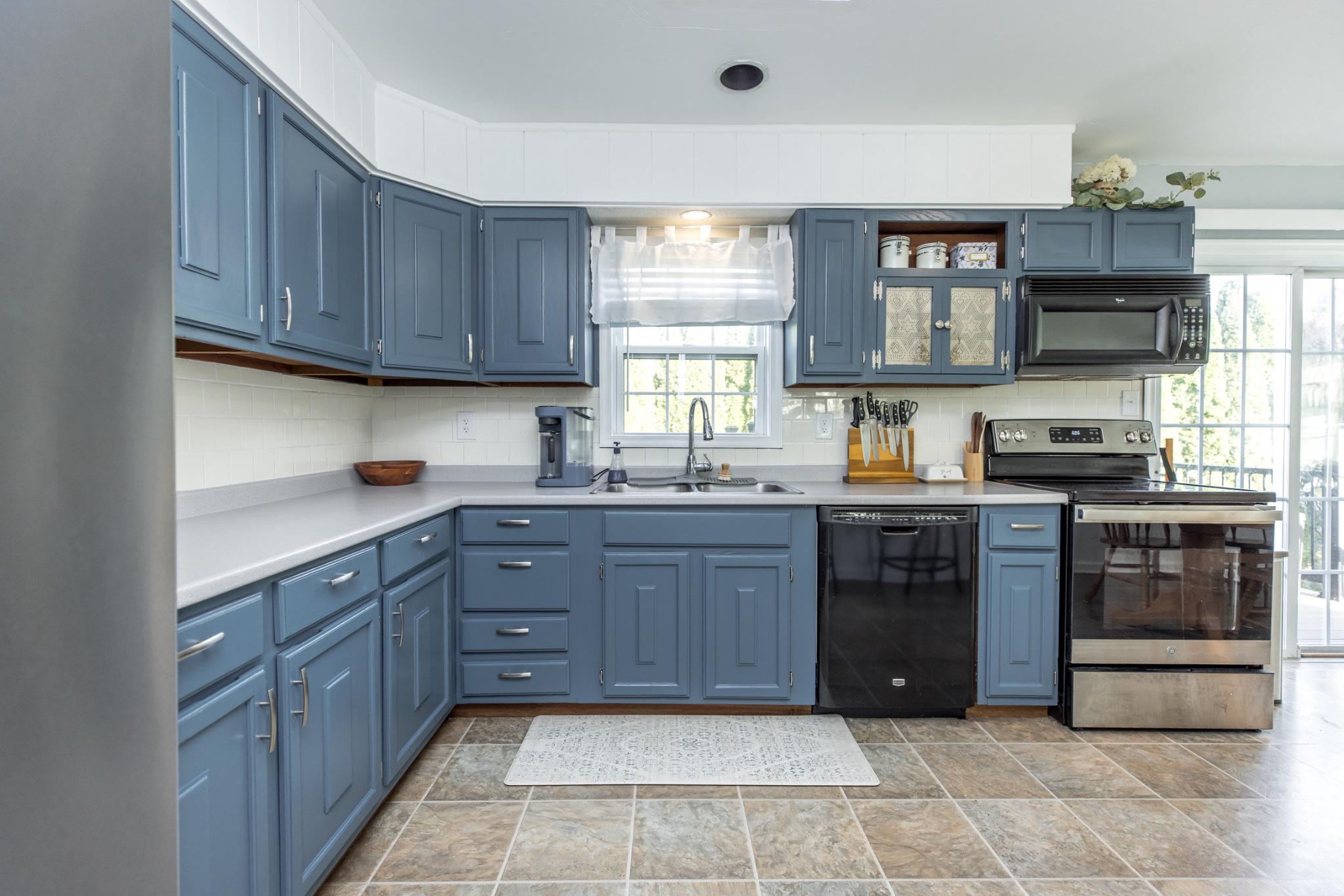 3427 York Street Manchester, MD 21102 - Photo 4 of 26 a kitchen with a sink and wooden cabinets