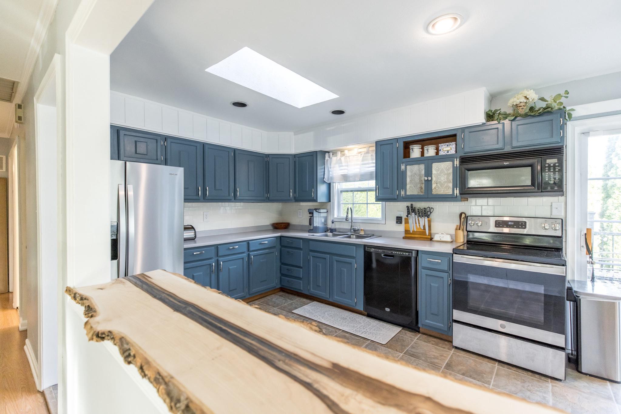 3427 York Street Manchester, MD 21102 - Photo 6 of 26 a kitchen with stainless steel appliances kitchen island granite countertop a refrigerator and a stove top oven